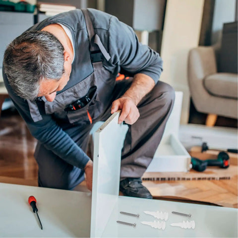 Man assembling furniture using Heavy Duty Wall Anchors Set With Screws For Drywall And Concrete, tools visible