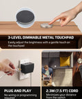 Person adjusting a Two Pack Touch Dimmer Switch With 3 Level Dimming And Touch Pad Control For LED CFL And Incandescent Bulbs 8 Ft Extension Cord ETL Listed Black Great For Any Room on a wooden desk with a metal touchpad. Plugged into a wall.