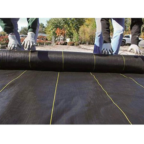 Heavy-Duty Weed Barrier Fabric 4 By 100 Feet Breathable Woven Polypropylene Ground Cover being installed outdoors
