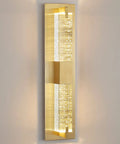 Hot Gold 19 Inch LED Wall Sconce with Crystal Bubble Glass on wall, warm 3000K lighting, modern indoor decor fixture vertical view.
