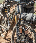 Mountain bike equipped with TetraRack M1 Fork Mount Rack For Bikes, Adjustable Top Plate Keeps Loads Level, and strapped gear.