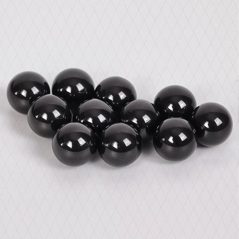 Fifty Piece Silicon Nitride Si3N4 Ceramic Balls Three Sixteenth Inch G5 Precision Bearing Spheres on background.