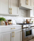 Top Tier Brushed Gold Cabinet Pulls 10 Pack 5 Inch Center To Center on modern kitchen cabinets with light gray finish.