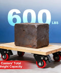 Heavy Duty Two Inch Caster Wheels With Twin Locking Brakes And Silent Polyurethane Treads That Make Moving Heavy Gear Feel Like Childs Play Fast Swivel Rolling Set Of Eight For Shop Garage with a 600 lb weight block on a wooden platform.