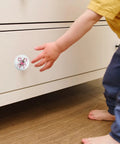 Festive Peppermint Ceramic Knob Covers For Cabinets And Drawers Super Easy Install Holiday Home Refresh Essentials Decorative Drawer Pulls With Screws For Winter Party Vibes Quick Upgrade. Child's hand reaching for a white ceramic knob on a drawer.