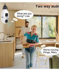 Image showing Dead Legit 8MP Dual Lens Wifi Ip Security Camera With E27 Bulb Mount observing two people moving furniture indoors.