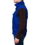 Side view of person wearing DVALIN Hybrid FR Leather Welding Jacket with leather sleeves and snap buttons for maximum protection.