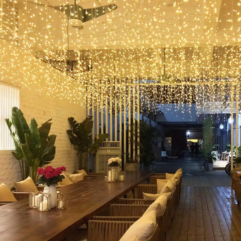Warm White LED Icicle String Lights For Windows And Outdoor Spaces 16.4Ft 216 LEDs illuminating outdoor patio area