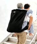 Person using Rock Solid One Person Transfer Sling For Seniors And Disabled Patients No Sweat Lifting Belt for stairs.