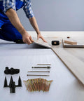 Person using Squeaky Floor Repair Kit with 250 screws and tools on hardwood floor for quiet home improvement.