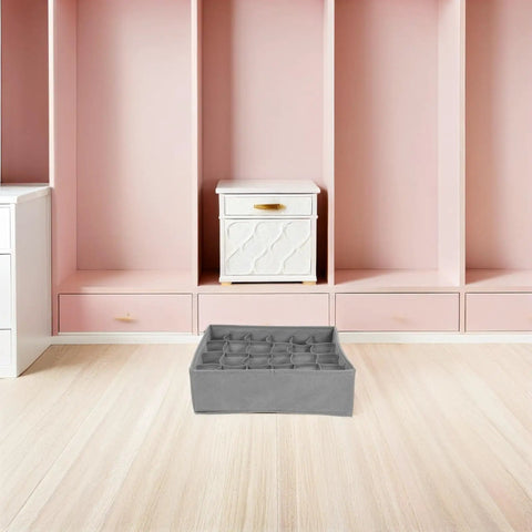 Set Of Three Foldable Cloth Underwear Organizers To Chill Out Drawer Chaos And Keep Your Closet Fresh While Giving Delicate Bras Extra Love During Your Busy Weekday Hustle, grey fabric organizer in a modern room.