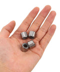 Four Piece Badass One Way Needle Bearing Set With 8mm Bore And 14mm Outer Diameter held in a hand, showing steel construction.
