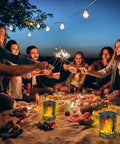 Group gathered around picnic table with Two Pack Solar Lanterns With Realistic Dancing Flame 99 LED Outdoor Lights for warm ambience
