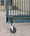 Spring Loaded Gate Rollers Heavy Duty Yard Fence Support Zero Drag Four Inch Black Driveway Casters Quick Install For Residential And Ranch Gates mounted on a gate.