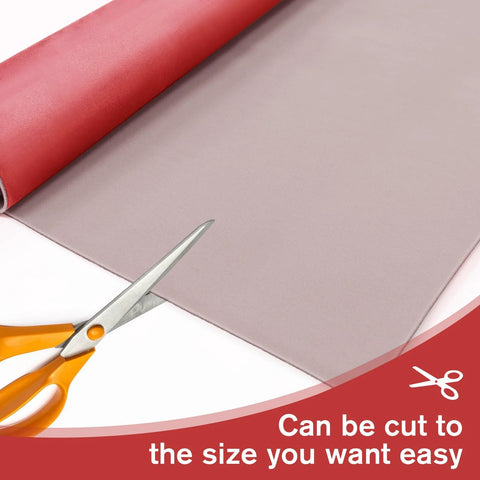 Angled view of suede headliner fabric with foam backing in red; automotive use, rolled sheet with scissors ready to cut
