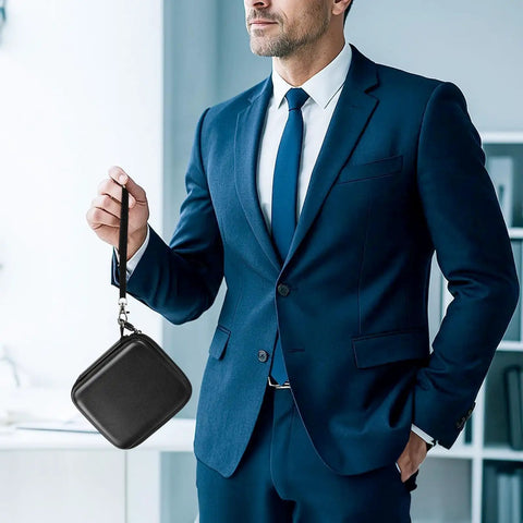 Person holding black Rugged Travel SSD Case For External Solid State Drives And Portable Storage in business attire.