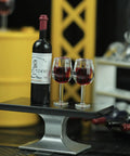 Hella Cool Miniature Red Wine Bottle Set Featuring Two Resin Filled Wine Glasses And A Static Corkscrew For Dollhouse Decor, showcasing bottle and glasses on a table.