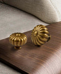 Four Pack Solid Brass Pumpkin Cabinet Knobs For Kitchen Drawers And Dressers Vintage Antique Copper Hardware on wood surface.
