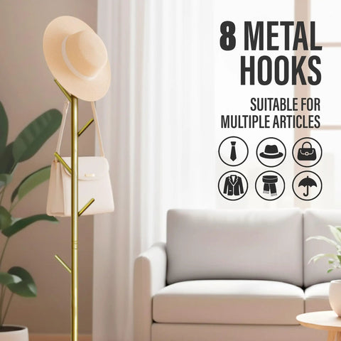 Freestanding Metal Coat Rack With 8 Hooks, Space Saving Hall Tree in gold next to a sofa holding a hat and bag.