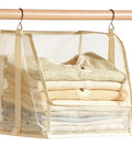 Premium Hanging Closet Organizer With Ultra Soft Fabric Shelves storing folded sweaters and towels in cream mesh design.