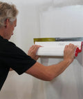 Person using a 32 Inch Composite Skimming Blade For Drywall Finishing With Replaceable 0.3mm German Stainless Steel Insert And Ergonomic Polymer Handle Smooth Mud Like Butter Easy Precision Pro Grade Finish on wall