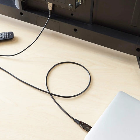50 Ft HDMI Fiber Optic Cable Featuring Gold Plated Connectors 18Gbps Throughput Ultra HD 4K At 60Hz Supports Ethernet connected to a TV.