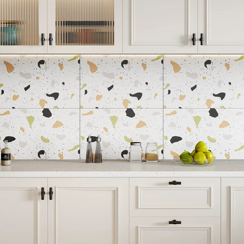 White kitchen cabinets with terrazzo backsplash and matte black cabinet knobs.