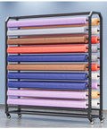 Rock Solid Heavy Duty Fabric Roll Storage Rack With Adjustable Hanging Rod and Smooth Rolling Locking Wheels for Vinyl Tablecloths displaying multiple rolls of fabric.
