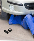 Mechanic installing Spare Tire Hold Down Bolt For Secure Mounting Heavy Duty Tire Retention Fastener near car's undercarriage
