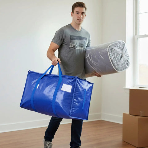 Person holding Ultra Large Moving Bags With Heavy Duty Zippers And Sturdy Carry Handles Waterproof Storage Bags For Moving Closet Organization And Camping 16 Pack Blue