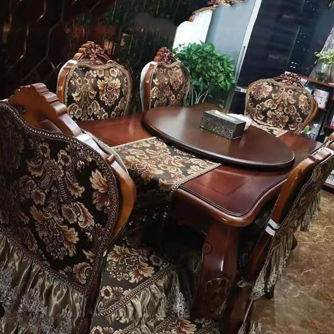 Elegant wooden dining table with ornate chairs and decorative table runner, perfect for hosting meals and gatherings.