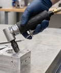 90 Degree Right Angle Pneumatic Air Die Grinder With Textured Non Slip Grip Built Tough For Sweet Access On Tight Jobs Auto Detailing And Heavy Duty Mold Trimming in use on aluminum block.