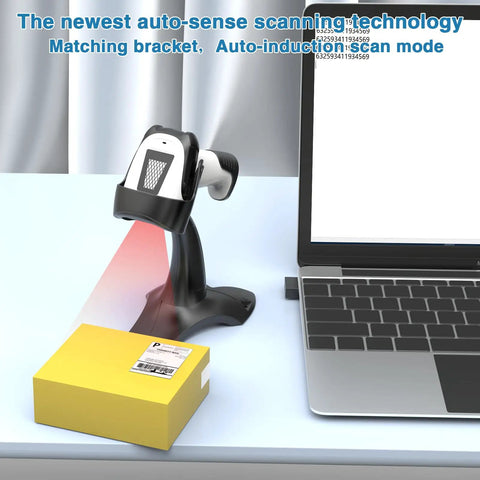 2D Handheld Wireless Barcode Scanner With Stand 3 In 1 Bluetooth Barcode And QR Scanner on a desk beside a laptop and package