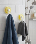 Rock Solid Adhesive Wall Hooks 1 Pack Killer Hold on ceramic tile holding a blue towel and gray cloth in a bathroom.