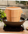 Premium Handcrafted Wood Steamed Rice Bucket With Lid, Round Beige Cask Storage Bin in black pot on kitchen counter.