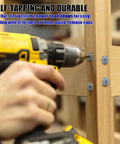 Pro Grade 1 1/4 Inch Cabinet Screws With T20 Square Drive in use, drilling into wood with a power tool.