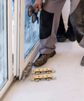 Worker installing Heavy Duty Aluminum Alloy Sliding Door Rollers Featuring Double Bearing Wheels For Slick Patio Track Replacement.