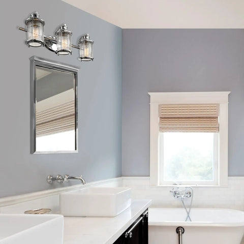 Three Light Vanity Light In Chrome With Ribbed Seeded Glass Shades For A Coastal Bathroom Vibe installed above mirror