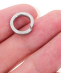 Stainless Steel M8 Split Spring Lock Washers Kit, 100 Pieces, Heavy Duty Corrosion Resistant Locking Washers For Bolts And Screws, General Repair And Machinery Maintenance, Easy Install And Secure Fit, close-up on fingers