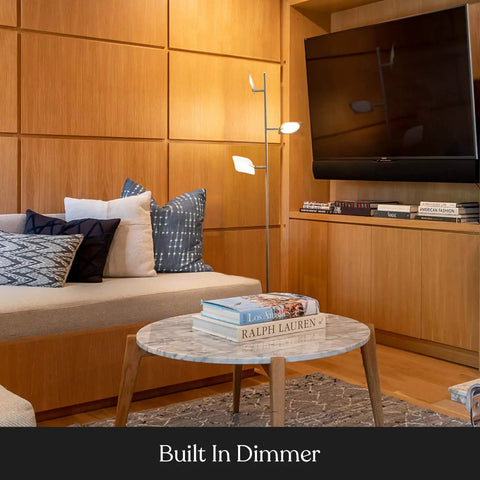 Tree Floor Lamp With Dimmable LED Spotlight next to a sofa in living room, adjustable panels lit, wooden wall background.