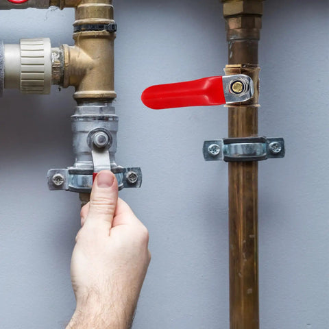 Hand operating red handle of Kickass 2Pcs Copper Ball Valve 6MM Fittings, showcasing garden piping system adjustment.