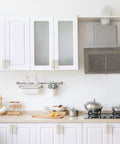 10 Pack Brushed Gold Cabinet Handles And Drawer Pulls For Kitchen Cabinets And Dressers Featuring Slick Zinc Alloy Body With Dope Fresh Look Plus 3.75 Inch Hole Spacing Great For Snazzy Vibe Upgrade Of Drawers And Cupboards Today in a modern kitchen with white cabinetry.