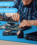Person working on electronics using an anti static mat for electronics workbench, highlighting heat resistance and safe grounding.