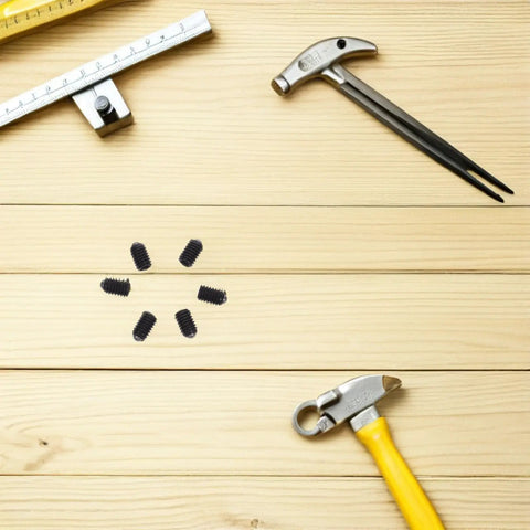 Big Time Stainless Steel Ball Plunger Set M4X6MM Spring Loaded Positioning Screws on wooden surface with tools around.
