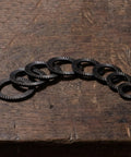 72 Piece Set Double Tooth Lock Washers Black Ironclad Grip 65mn Steel showing multiple washers on wooden surface.