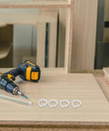 100 Piece M8 Stainless Steel Split Lock Washers Heavy Duty Spring Locking Rings For Fasteners And Auto Parts on a wooden workbench.