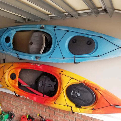 Top Shelf Badass Kayak Wall Mount Rack For Garage Storage showcasing blue and orange kayaks securely hung, preserving space.