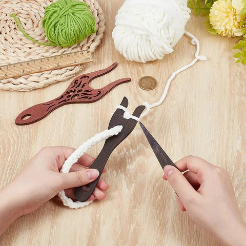 Hands using Three Piece Wooden Knitting Fork And Weaving Tools Kit With Lucet Fork For Bracelet And Necklace Braiding DIY Projects In Boxwood And Beech Wood Durable And Lightweight For Comfortable Use And Long Lasting DIY Craft Sessions on wooden surface with yarn.