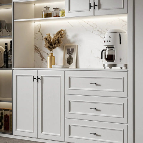 Modern kitchen cabinet with matte black handles, three drawers, and wall shelves, featuring minimalist decor and a coffee maker.