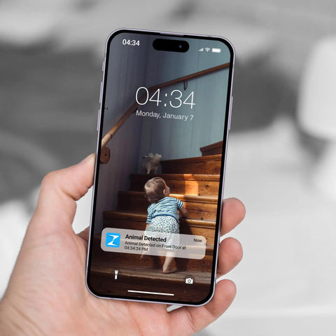 Smartphone displaying 1080p Indoor Security Camera With AI Motion Detection And 2 Way Audio alert notification.
